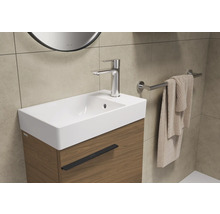 Vasque avec robinet, serviette et porte-serviettes dans la salle de bain