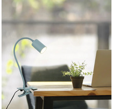 Klemmlampe auf einem Schreibtisch mit Laptop und Dekoration