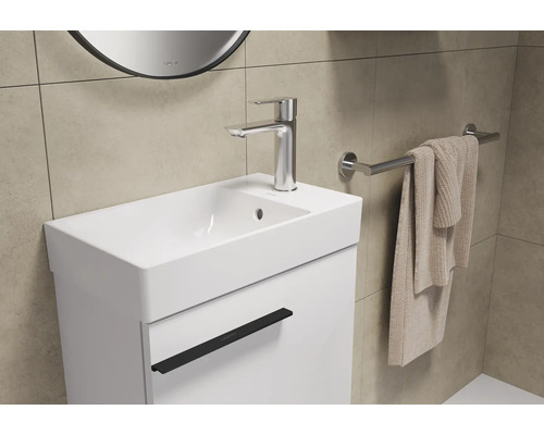 Meuble-lavabo avec lavabo, robinet, serviette et porte-serviettes dans la salle de bain