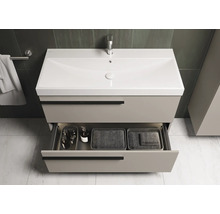 Meuble sous-lavabo avec tiroir ouvert dans une salle de bain