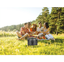 Gruppe von Freunden beim Picknick mit Grill im Freien