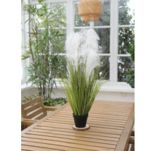 Plante artificielle décorative avec plumes dans un pot sur une table en bois