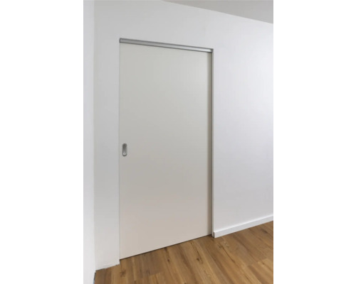 Porte coulissante blanche devant un mur blanc