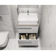 Salle de bains moderne avec lavabo, meuble sous-vasque et tiroir ouvert pour ranger les accessoires de salle de bains