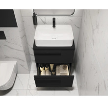 Salle de bains moderne avec meuble-lavabo noir, vasque à poser blanche et tiroir ouvert