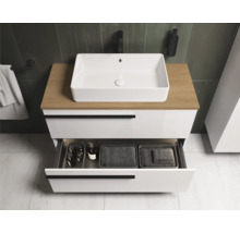 Meuble sous-vasque avec tiroir ouvert et vasque à poser dans une salle de bain