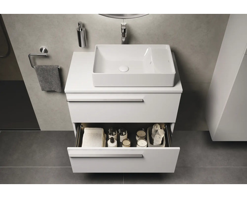 Meuble-lavabo avec tiroir ouvert et vasque à poser dans la salle de bains