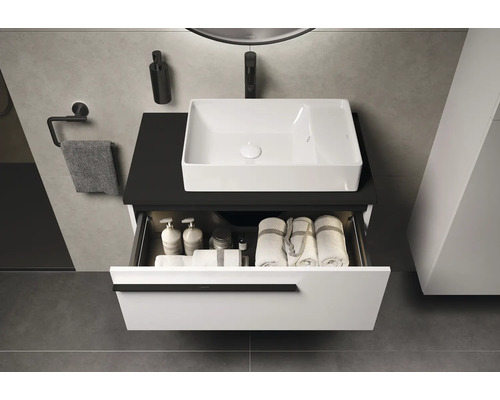 Lavabo de salle de bain avec élément de tiroir ouvert, serviettes et accessoires de salle de bain