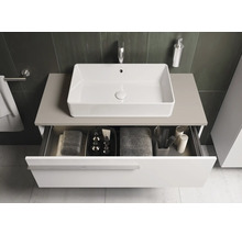 Meuble sous-lavabo avec tiroir en dessous, sur lequel est monté un lavabo.