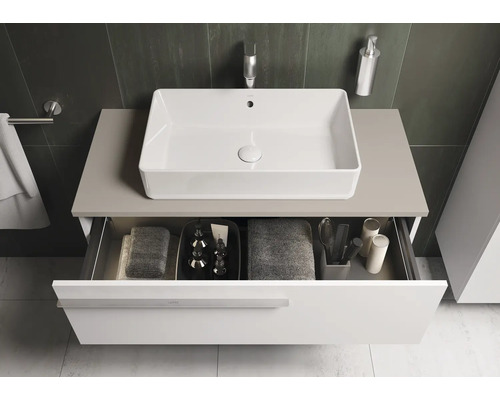 Meuble sous-lavabo avec tiroir en dessous, sur lequel est monté un lavabo.