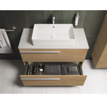 Salle de bains moderne avec meuble sous-vasque, vasque à poser et tiroir ouvert.