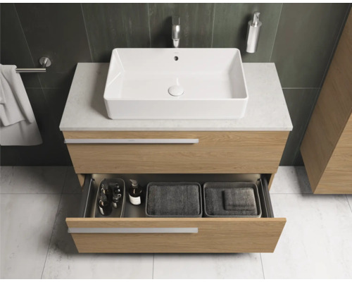 Salle de bains moderne avec meuble sous-vasque, vasque à poser et tiroir ouvert.