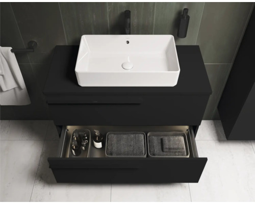 Meuble-lavabo avec vasque à poser blanche et meuble bas noir avec tiroir ouvert