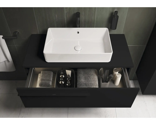 Meuble sous-lavabo avec tiroir ouvert et vasque à poser blanche