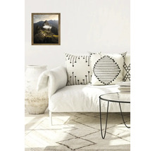 Salon avec une image encadrée du Machu Picchu, coussins, table basse et tapis.