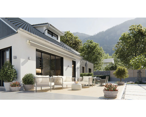 Maison avec terrasse, mobilier de jardin et vue sur la montagne