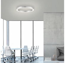 Une salle de réunion avec un plafonnier LED rond.