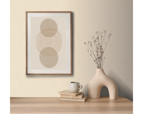 Image décorative avec motif de cercle dans un cadre en bois, sur une table avec un vase décoratif et des livres