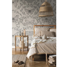 Chambre avec lit, table de chevet, lampe et papier peint à motifs de papillons