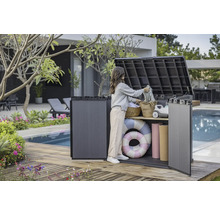 Photo d'une femme utilisant une boîte de rangement extérieure sur une terrasse en bois près d'une piscine pour ranger des objets