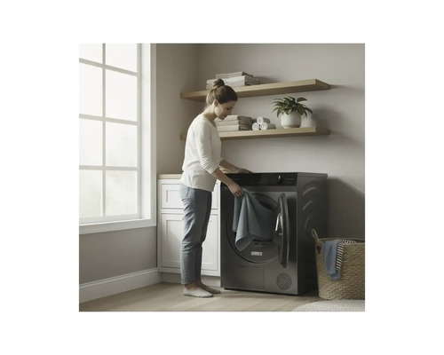 Femme mettant du linge dans un sèche-linge dans une pièce lumineuse.