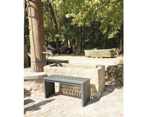 Aussenszene mit einer Bank vor einem Steintrog