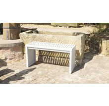 Banc de jardin blanc en métal avec lattes devant un bac en pierre