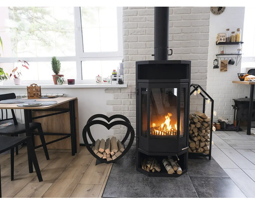 Salon avec poêle à bois, bois de chauffage et table à manger