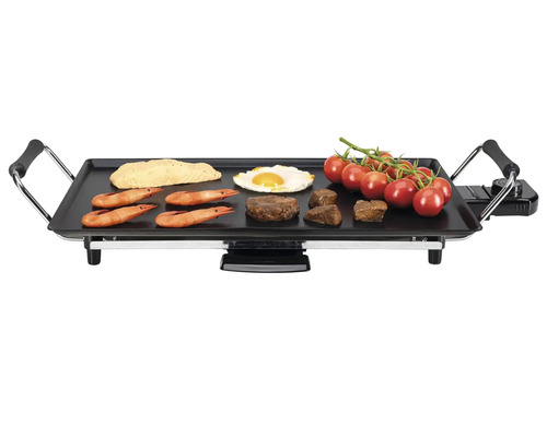 Gril électrique avec divers aliments comme steak, œufs, tomates et crevettes