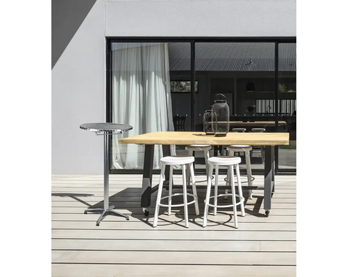 Espace extérieur avec table de bar, tabourets de bar et table d'appoint sur une terrasse