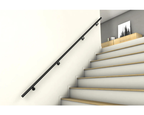 Main courante d'escalier noire sur un mur à côté d'un escalier