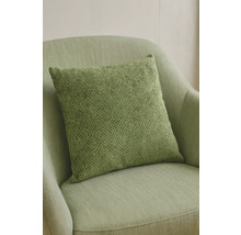 Coussin décoratif vert sur un fauteuil