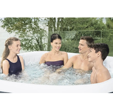 Familie entspannt in einem aufblasbaren Whirlpool im Garten.