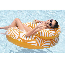 Femme se détend sur un fauteuil de piscine gonflable dans l'eau