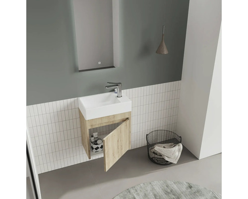 Salle de bain moderne avec lavabo, miroir, lampe et panier à linge.
