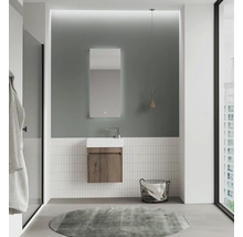 Salle de bains moderne avec lavabo, miroir, panier à serviettes et tapis rond