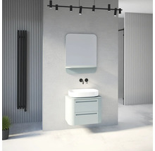 Salle de bains moderne aspect béton avec meuble vert menthe, vasque à poser blanche, miroir, robinetterie murale noire et radiateur.