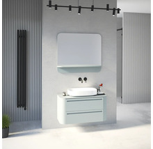 Salle de bain moderne avec meuble sous vasque suspendu vert clair, vasque à poser, robinetterie murale noire, miroir et radiateur noir.
