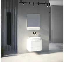 Ensemble de salle de bains moderne avec meuble sous-vasque blanc, vasque à poser, miroir et robinetterie murale noire dans une pièce lumineuse.