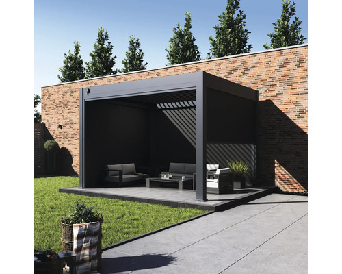 Pergola avec mobilier de jardin sur une terrasse devant un mur en briques