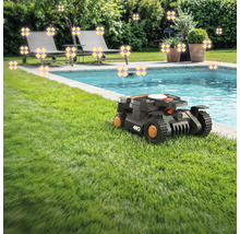 Scène avec un robot tondeuse sur une pelouse à côté d'une piscine, de chaises longues et de plantes
