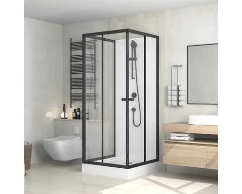Salle de bain avec cabine de douche, lavabo, miroir et toilettes dans un design lumineux