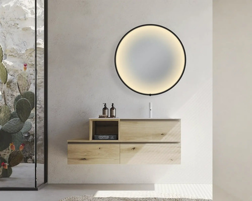 Salle de bains moderne avec meuble-lavabo, miroir rond avec rétroéclairage et paroi de douche en verre.