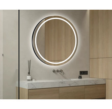 Miroir rond avec éclairage LED dans une salle de bains.