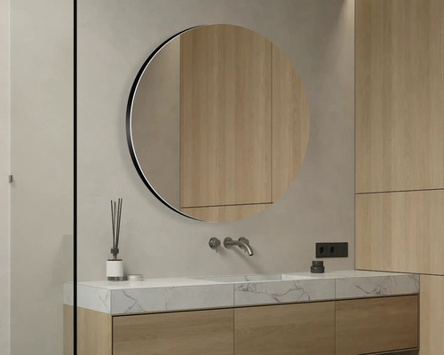 Salle de bains moderne avec miroir rond, lavabo et armoires en bois