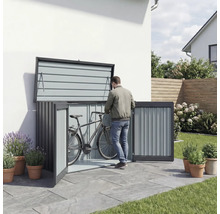 Box à vélos en métal avec portes ouvertes et une personne y rangeant un vélo.