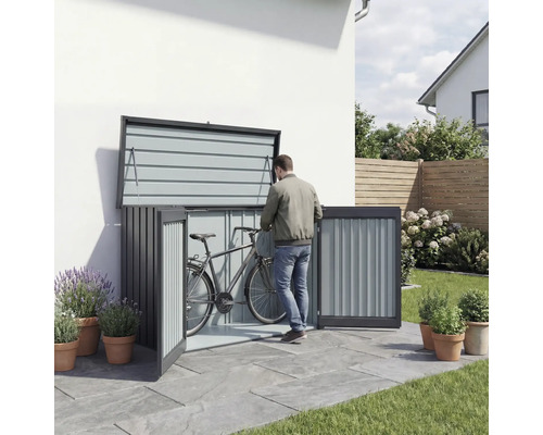 Box à vélos en métal avec portes ouvertes et une personne y rangeant un vélo.