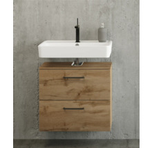 Meuble sous-vasque moderne en aspect chêne avec deux tiroirs, vasque à poser blanche et robinet noir devant un mur en béton.