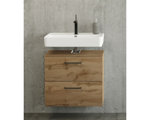 Meuble sous-vasque moderne en aspect chêne avec deux tiroirs, vasque à poser blanche et robinet noir devant un mur en béton.