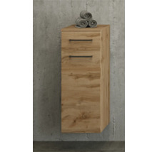 Meuble de salle de bain suspendu aspect chêne avec un tiroir, une porte et des poignées noires sur un mur en béton.